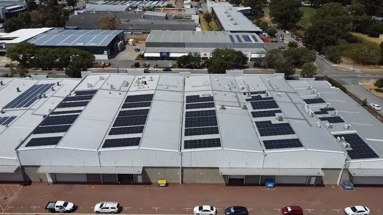 Solar arrays across the roof of a large industrial facility