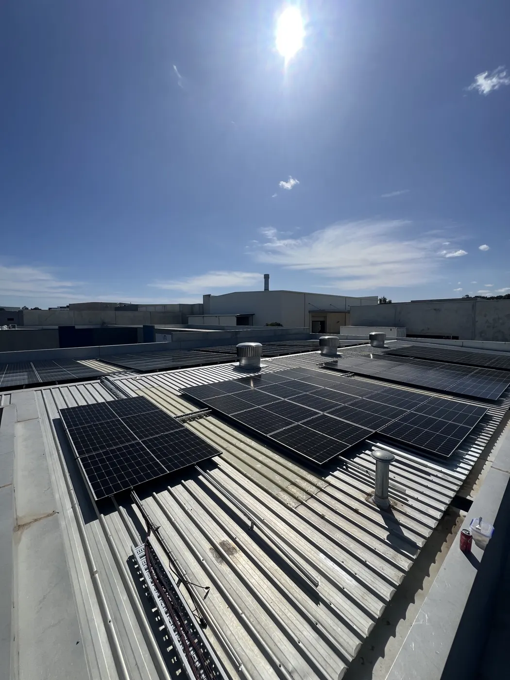 Rows of solar panels on the Custom Bench Tops factory roof