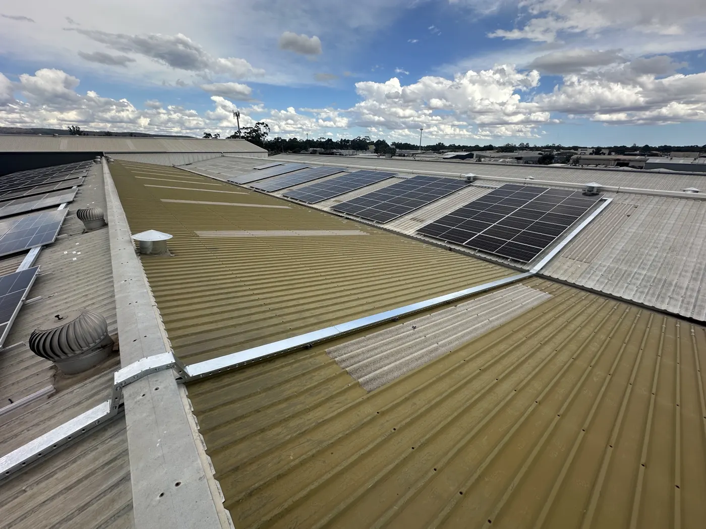 Solar array on the factory roof under a cloudy sky