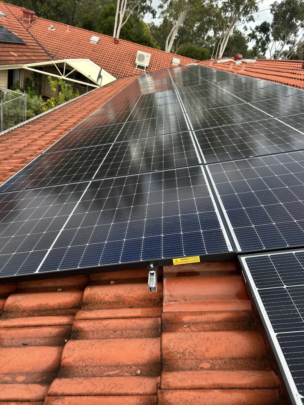 Close view of the solar array on a tiled roof at MercyCare Kelmscott